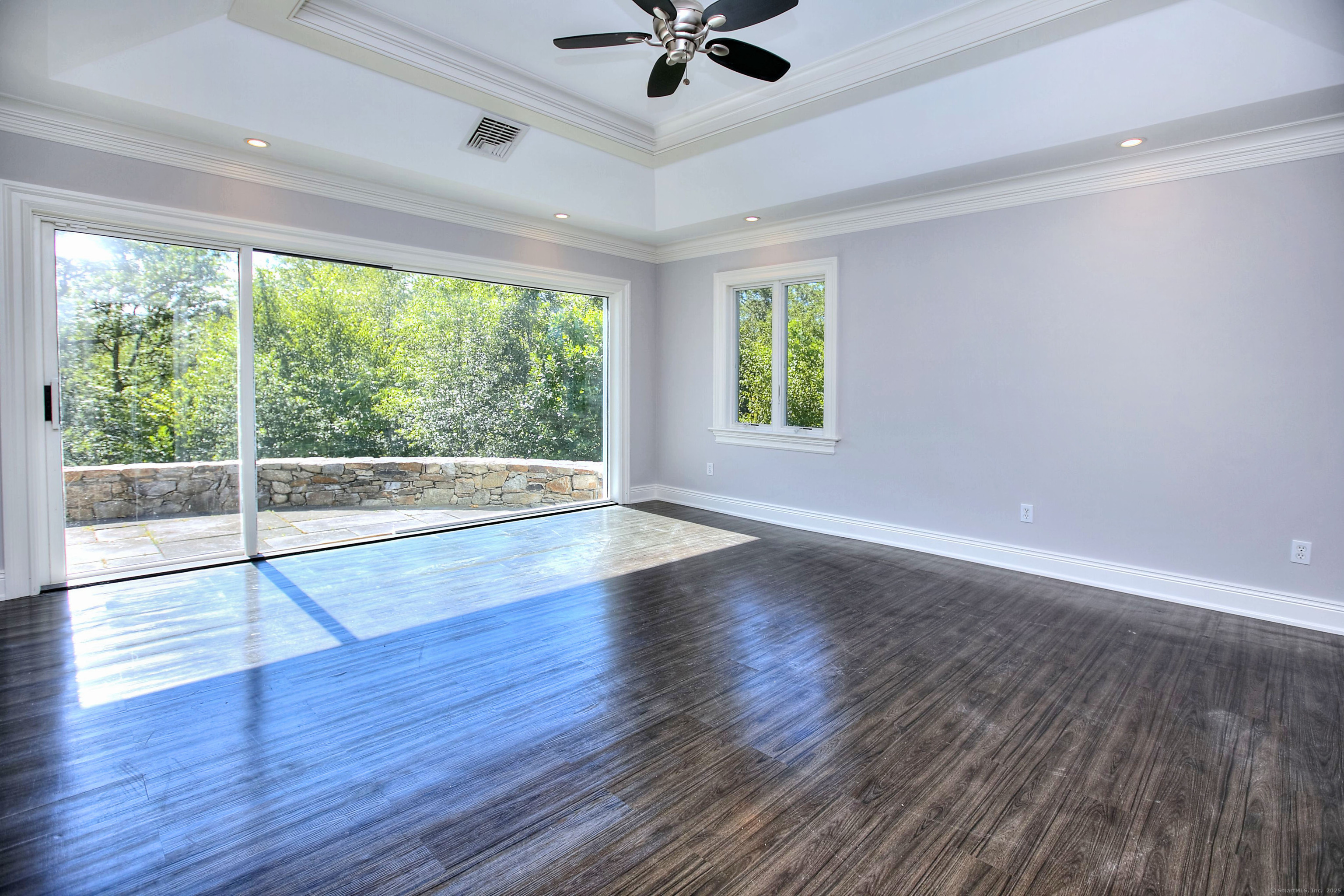 27 Rogues Ridge Road Weston, CT 06883 - Photo 21 of 39 a view of wooden floor and a chandelier fan in a room