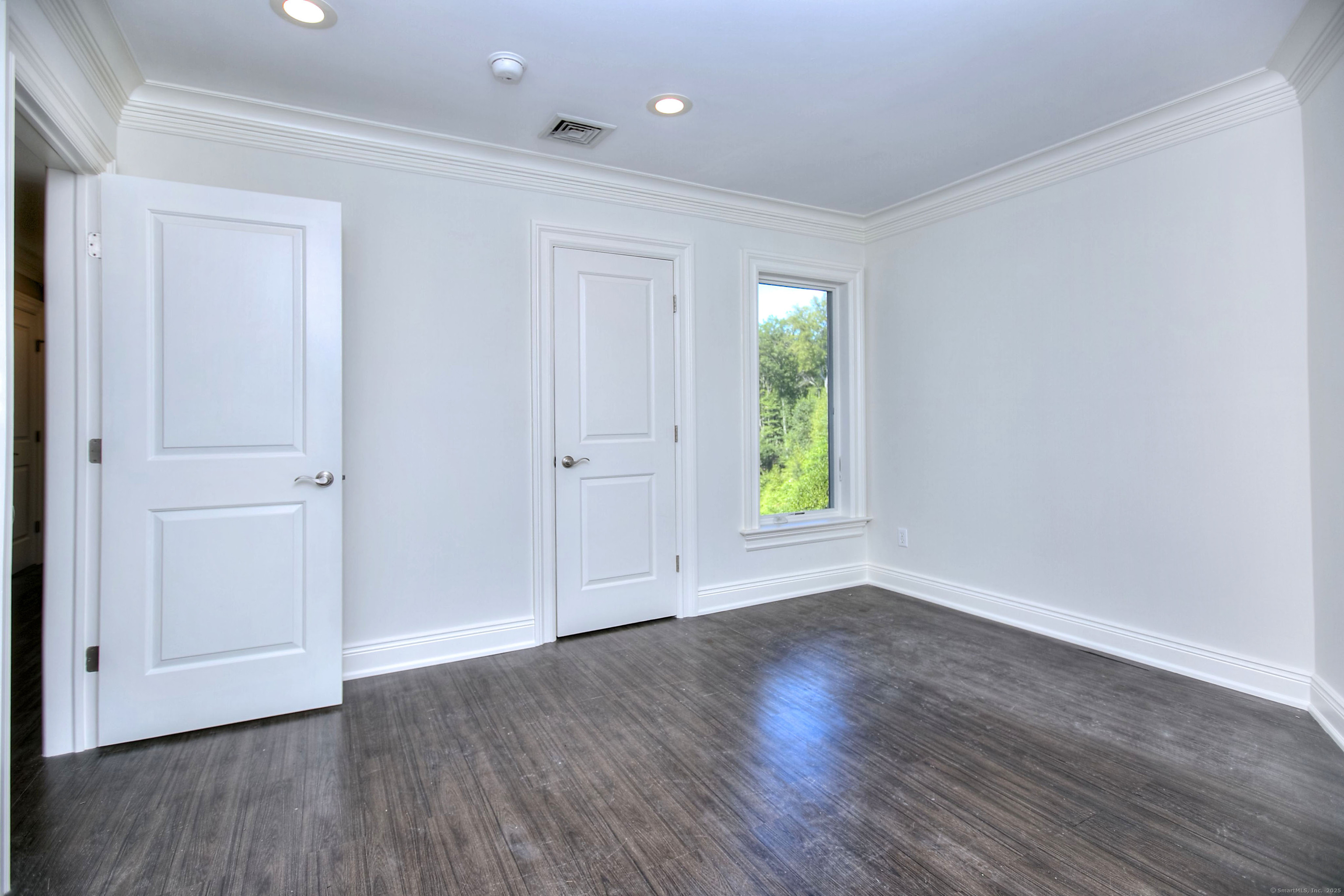 27 Rogues Ridge Road Weston, CT 06883 - Photo 26 of 39 an empty room with wooden floor and windows