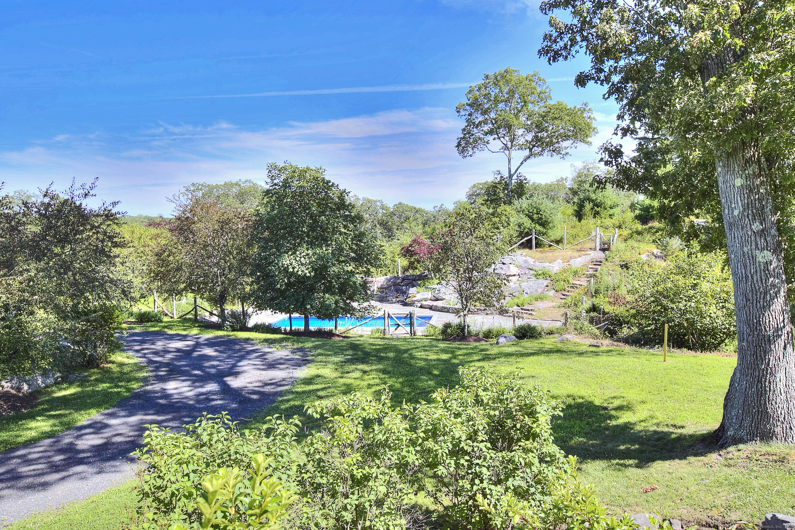 27 Rogues Ridge Road Weston, CT 06883 - Photo 30 of 39 a backyard of a house with lots of green space