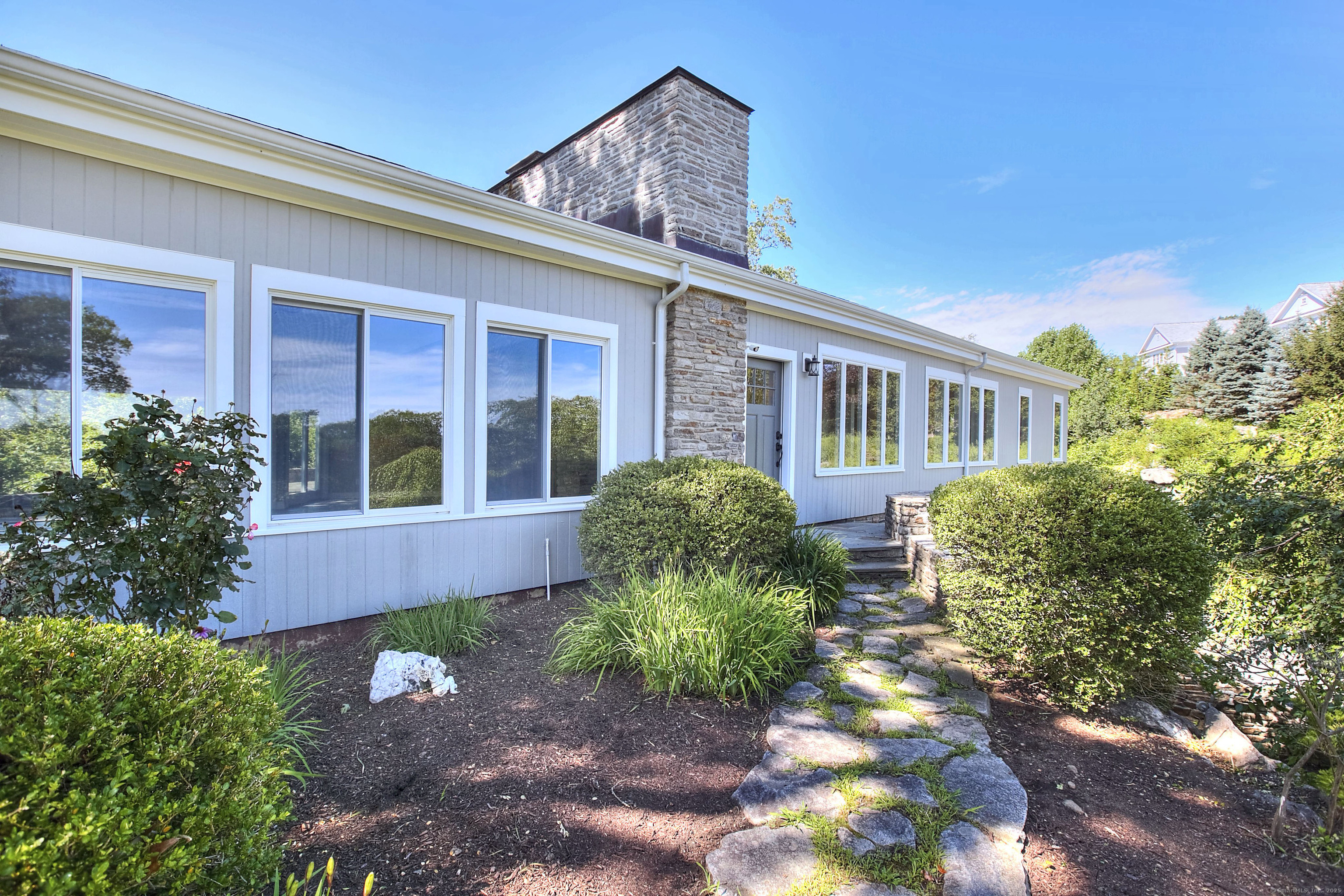 27 Rogues Ridge Road Weston, CT 06883 - Photo 3 of 39 front view of a house with a yard