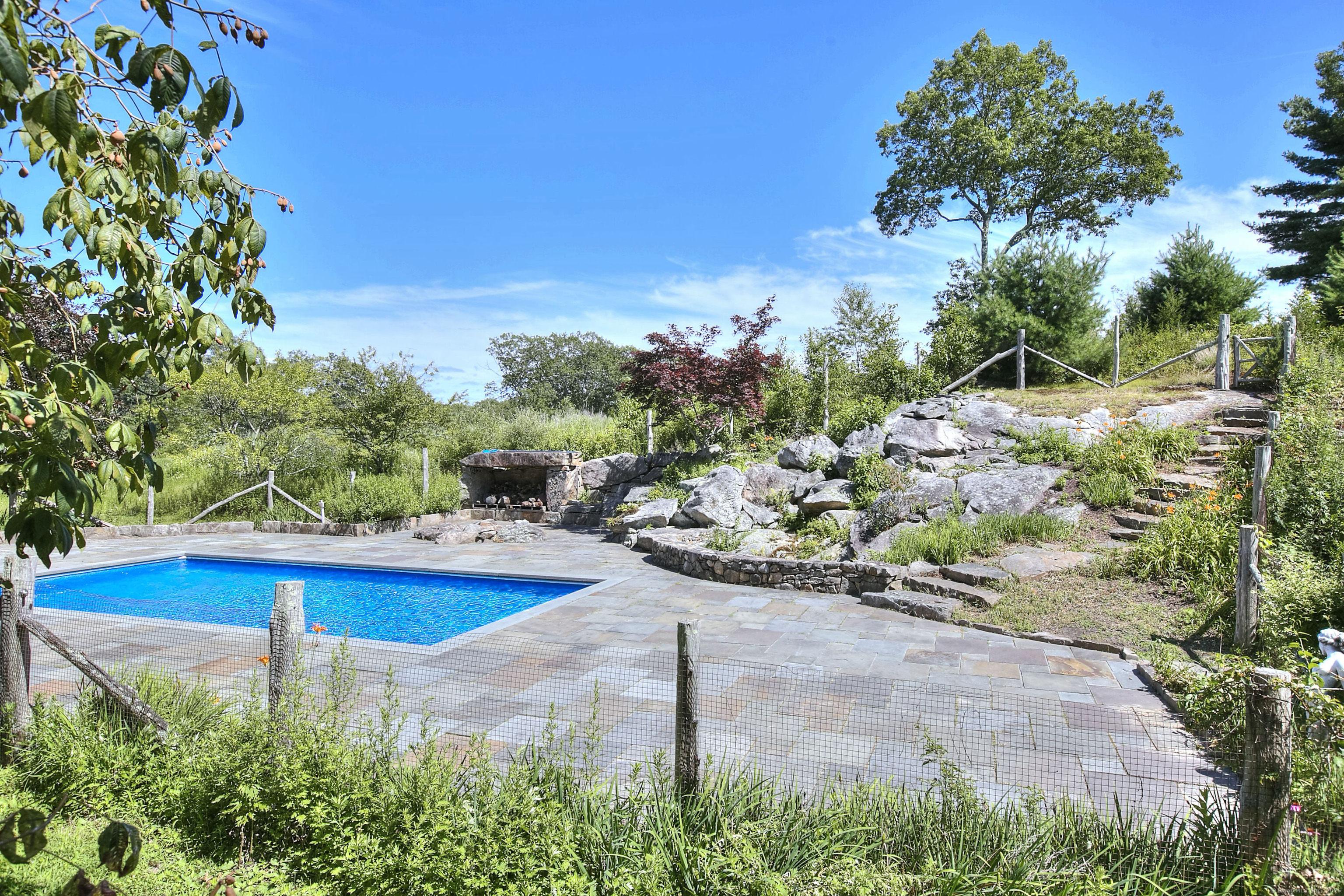 27 Rogues Ridge Road Weston, CT 06883 - Photo 36 of 39 a view of a backyard with plants and patio