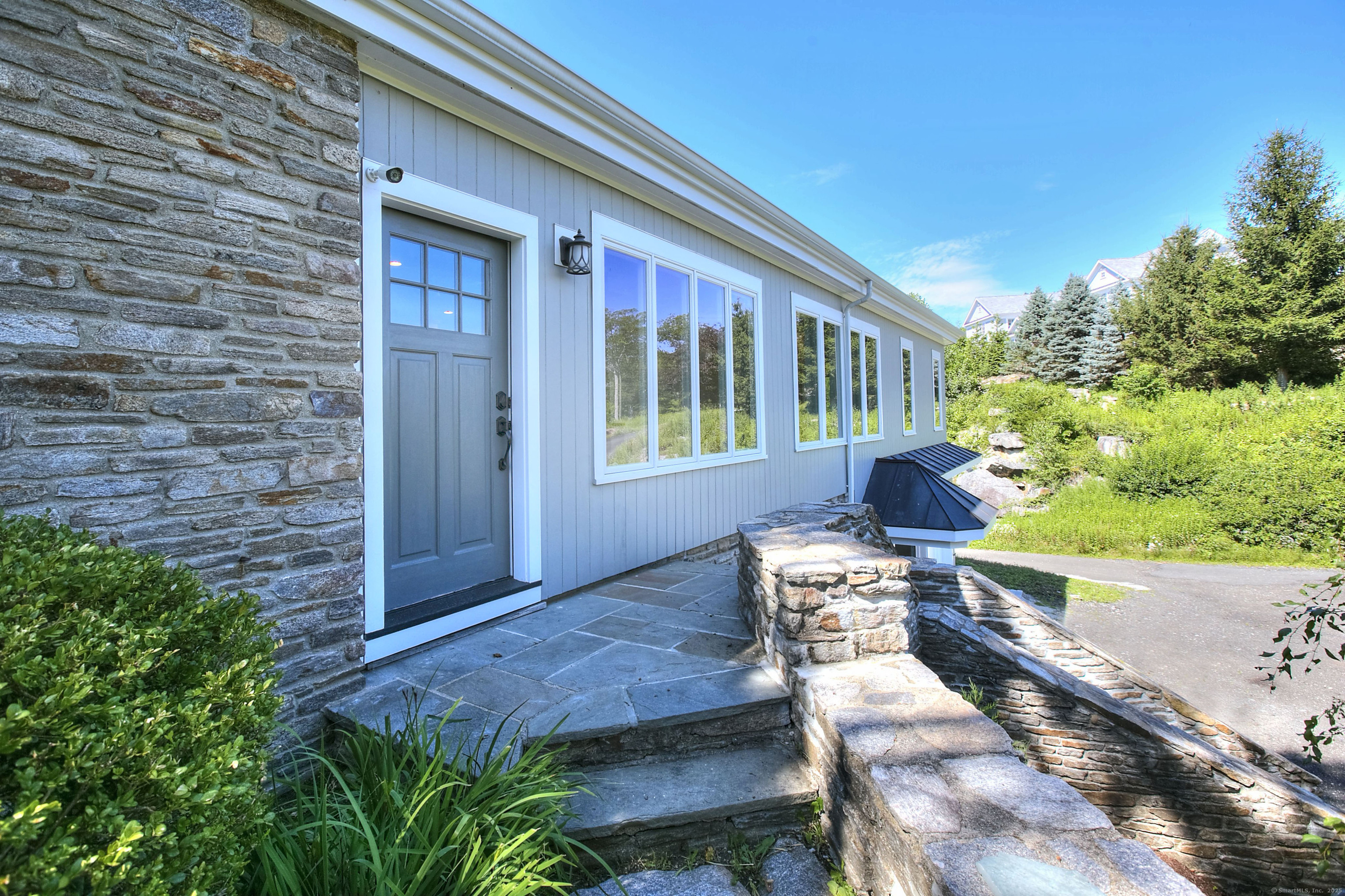 27 Rogues Ridge Road Weston, CT 06883 - Photo 4 of 39 a front view of a house with outdoor seating