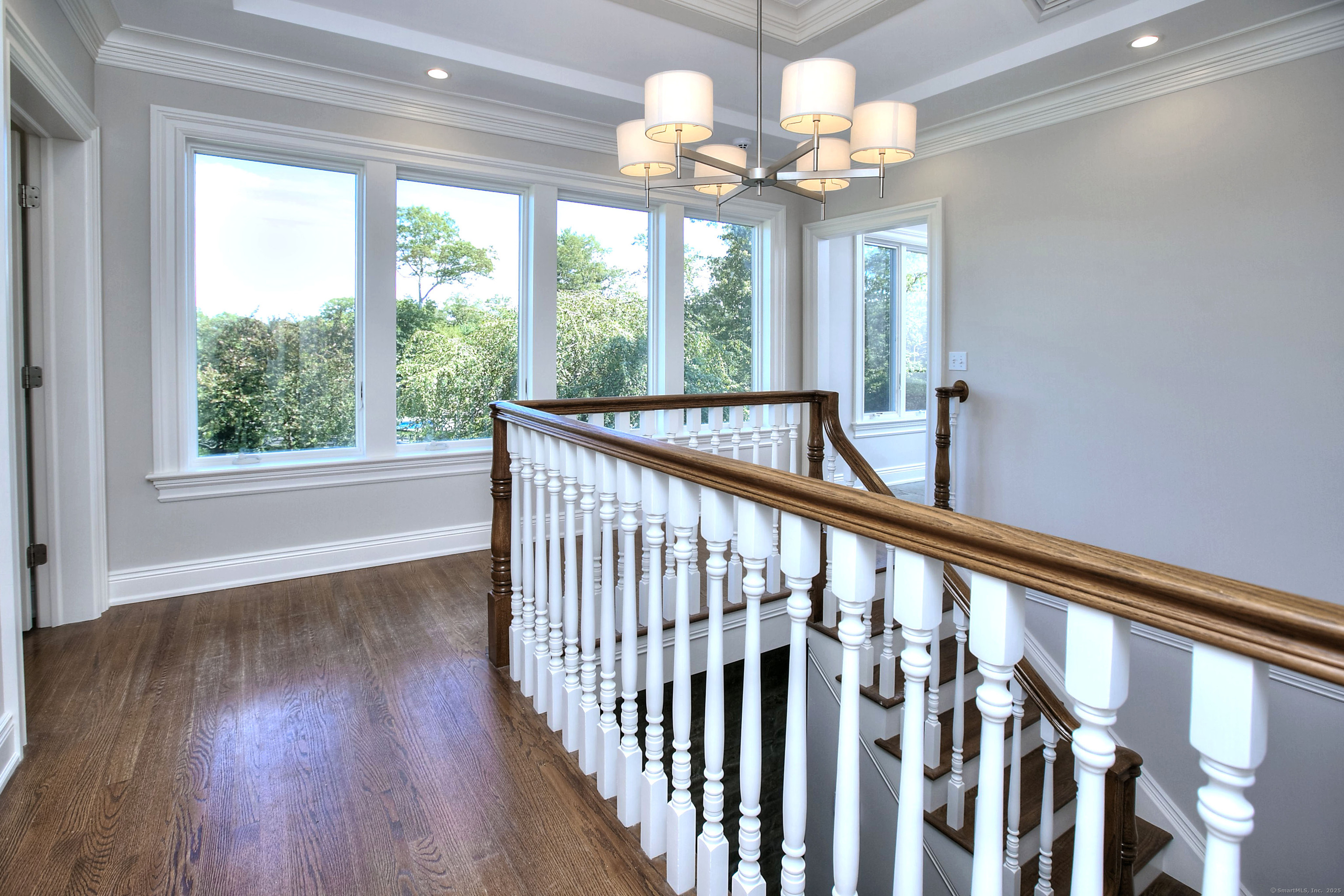 27 Rogues Ridge Road Weston, CT 06883 - Photo 5 of 39 a view of a porch with wooden floor staircase and a chandelier