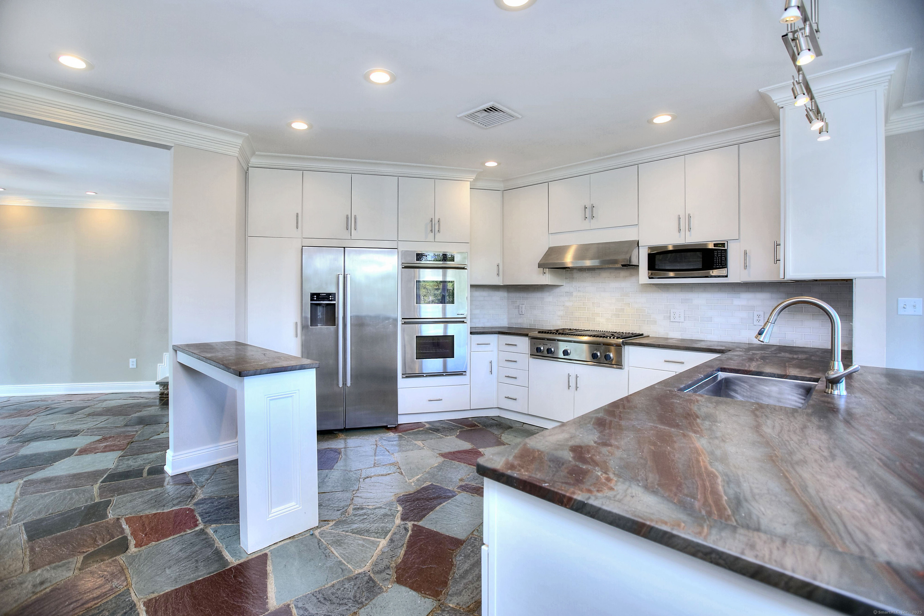 27 Rogues Ridge Road Weston, CT 06883 - Photo 7 of 39 a kitchen with stainless steel appliances granite countertop a refrigerator sink and stove