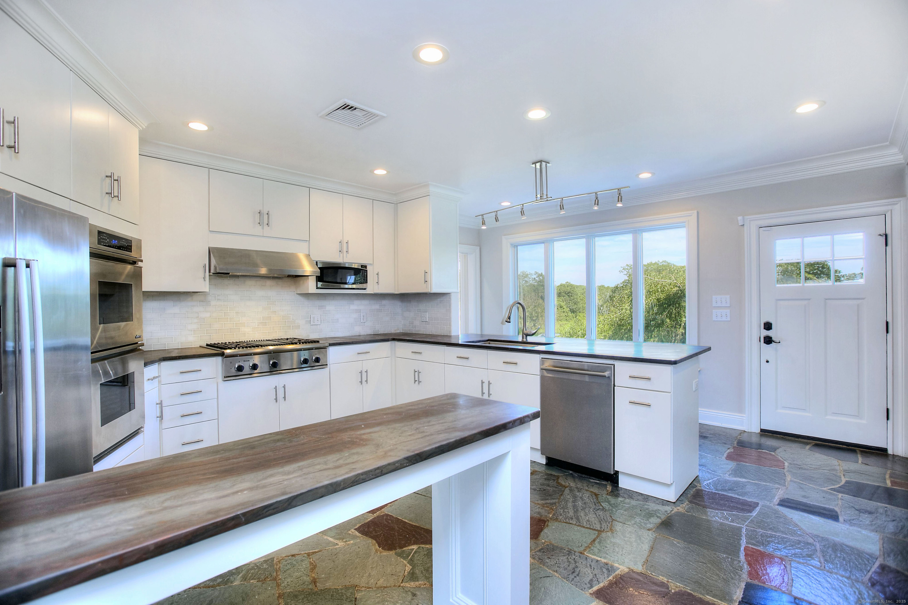 27 Rogues Ridge Road Weston, CT 06883 - Photo 9 of 39 a large kitchen with stainless steel appliances granite countertop a stove a sink and a refrigerator