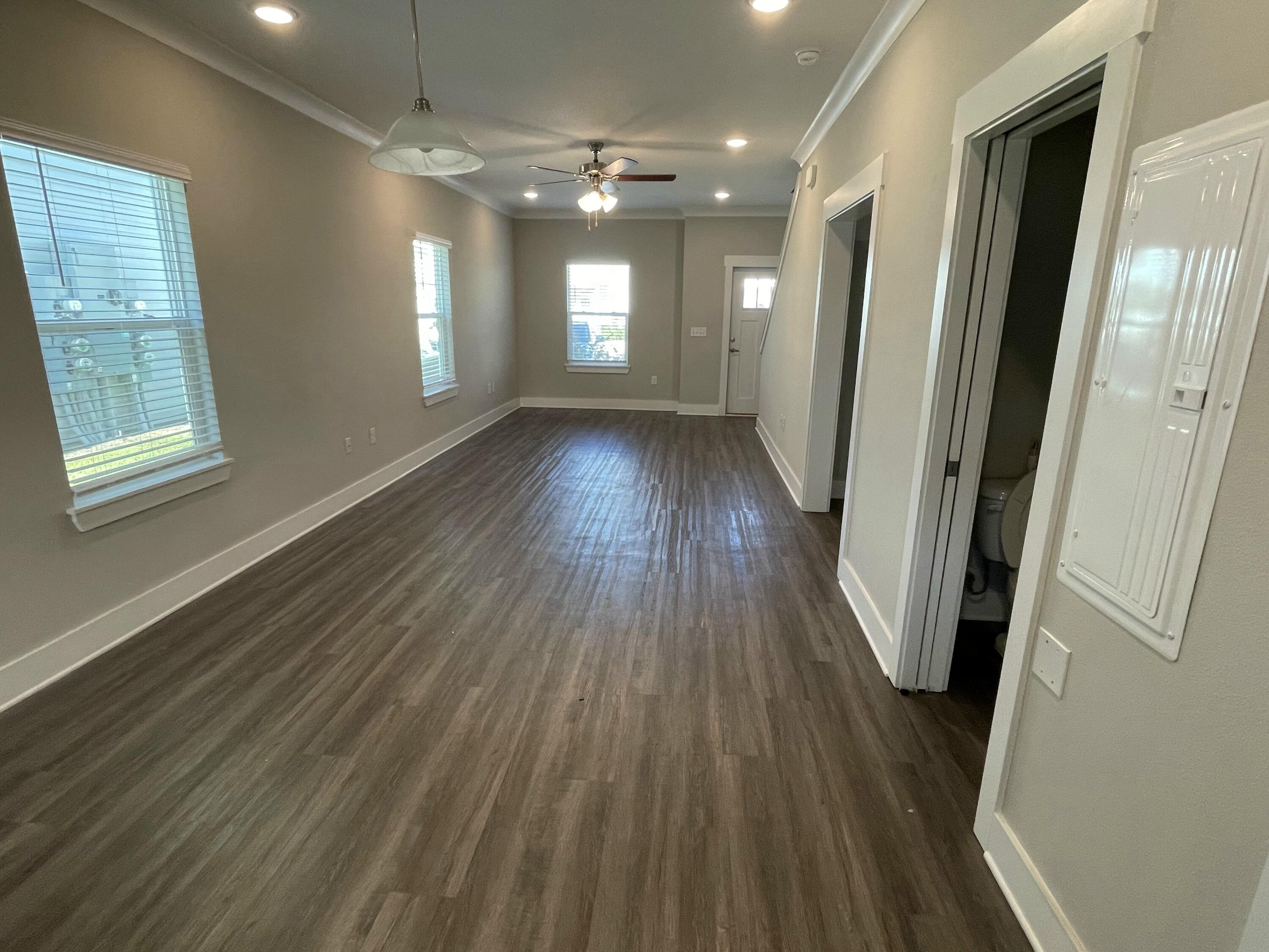 245 North Sand Palm Road Freeport, FL 32439 - Photo 3 of 27 wooden floor in an empty room with a window