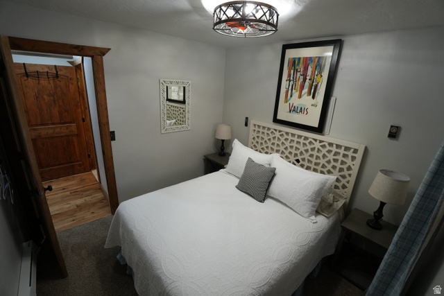 3711 North Canyon Road Provo, UT 84604 - Photo 14 of 42 Bedroom featuring baseboard heating, carpet flooring, and wood finished floors