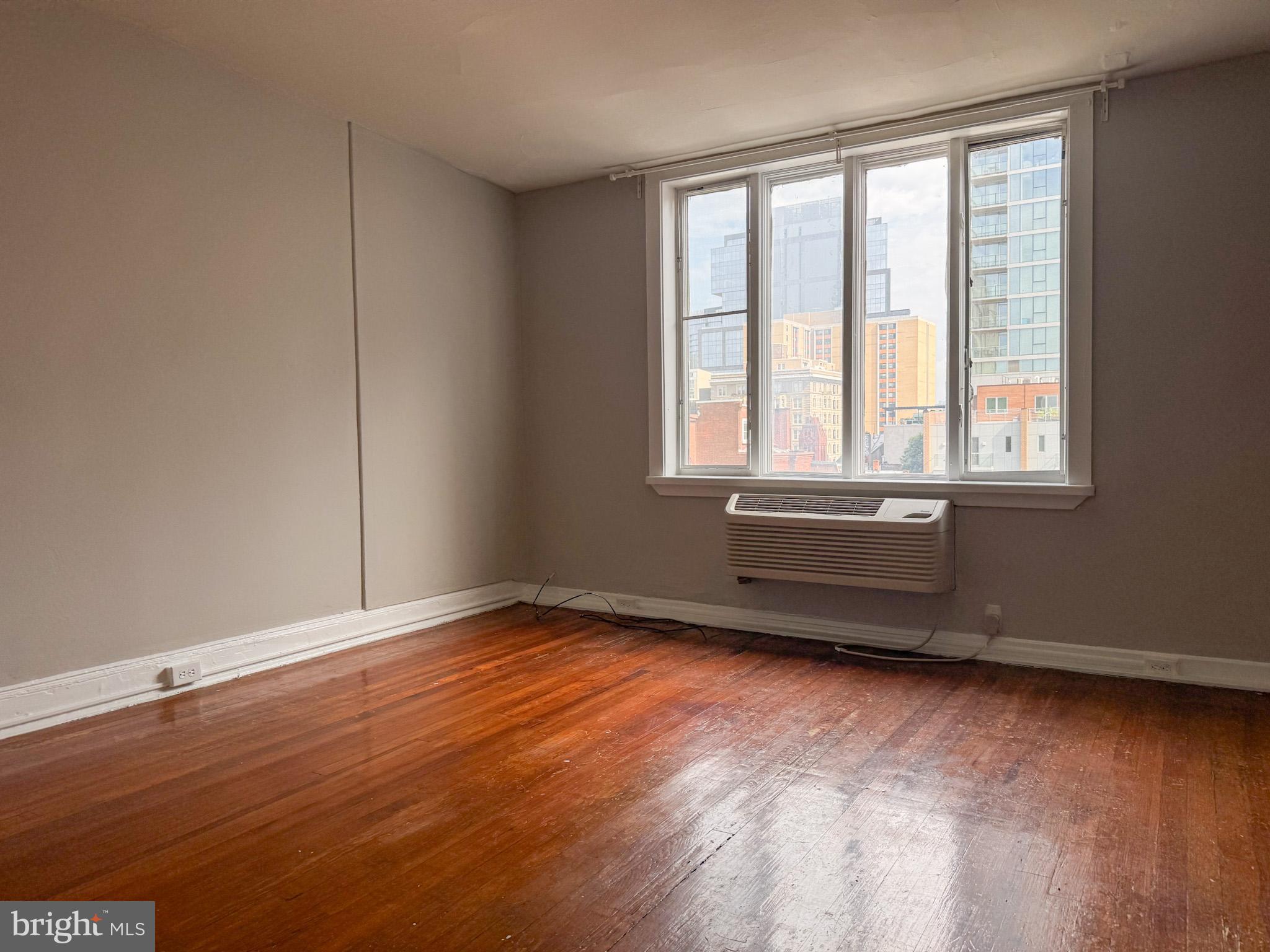 2125 Walnut Street, Unit 4 Philadelphia, PA 19103 - Photo 4 of 12 an empty room with wooden floor and windows