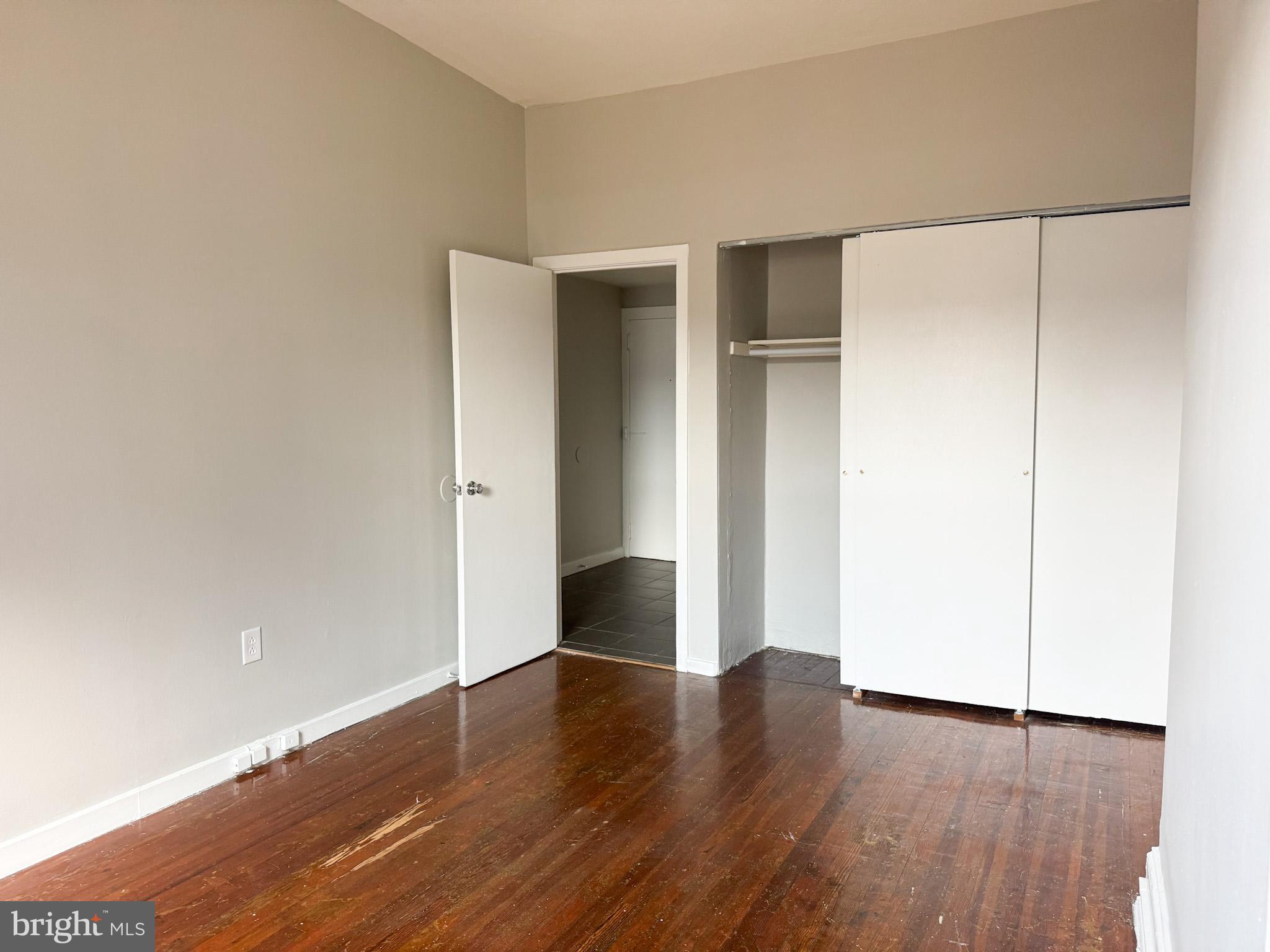 2125 Walnut Street, Unit 4 Philadelphia, PA 19103 - Photo 8 of 12 an empty room with wooden floor and closet