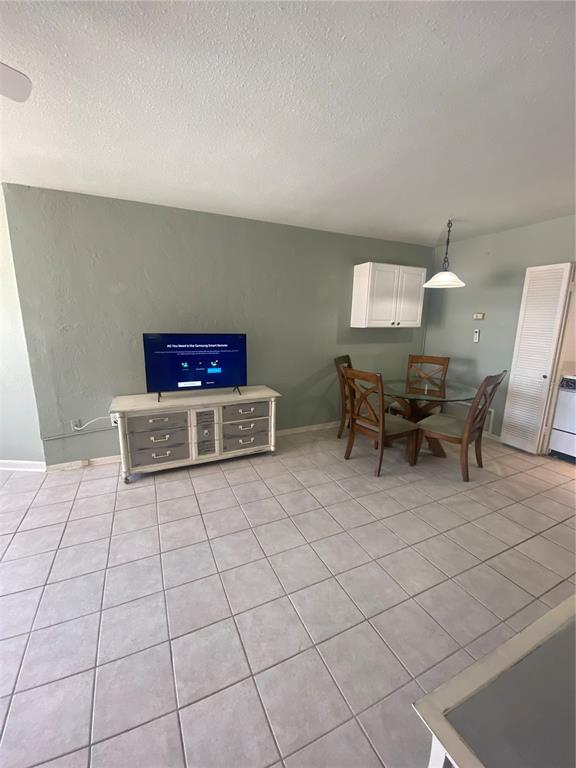 16400 Gulf Boulevard, Unit 707 North Redington Beach, FL 33708 - Photo 6 of 20 a living room with chairs and a table