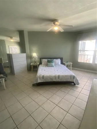 a bedroom with a bed and lamp with window