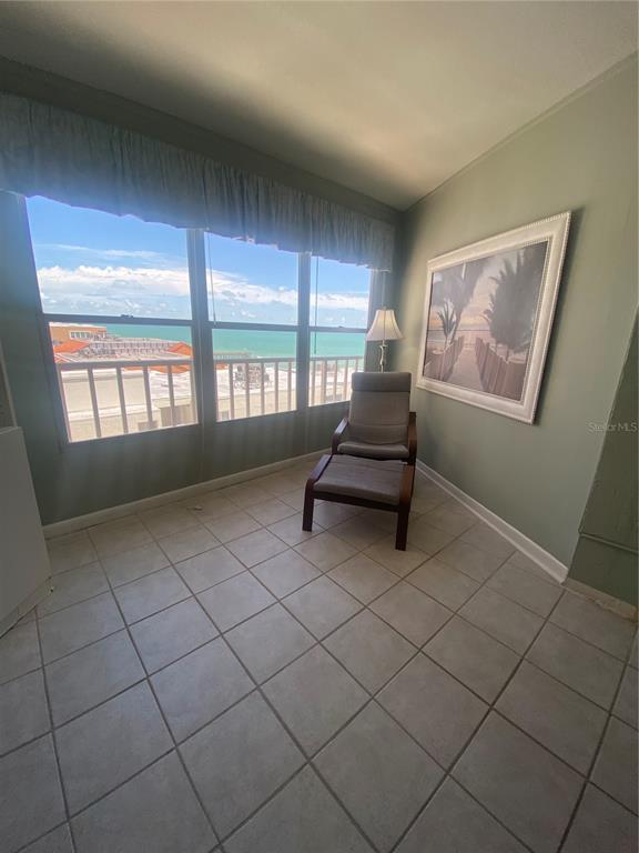 16400 Gulf Boulevard, Unit 707 North Redington Beach, FL 33708 - Photo 9 of 20 a living room with furniture and a floor to ceiling window