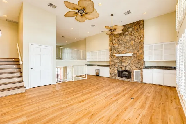 a view of a livingroom with a fireplace and wooden floor