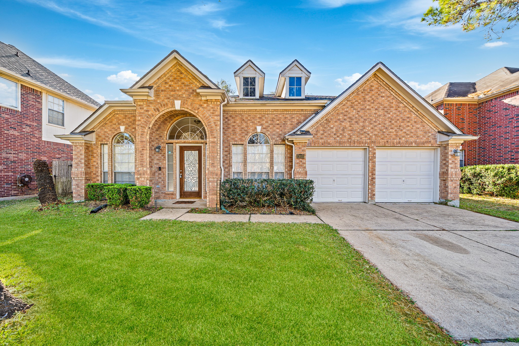 a front view of a house with a yard and garage