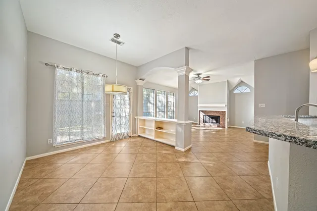 a large white kitchen with granite countertop a sink and a large window