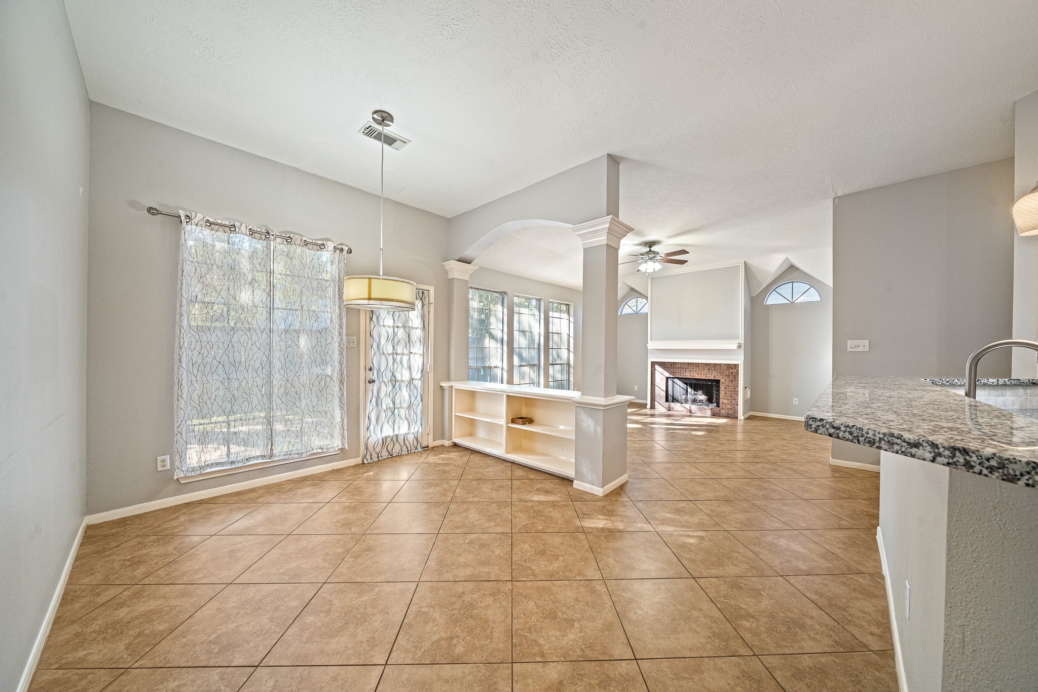 23223 Hazel Field Court Katy, TX 77494 - Photo 14 of 27 a large white kitchen with granite countertop a sink and a large window