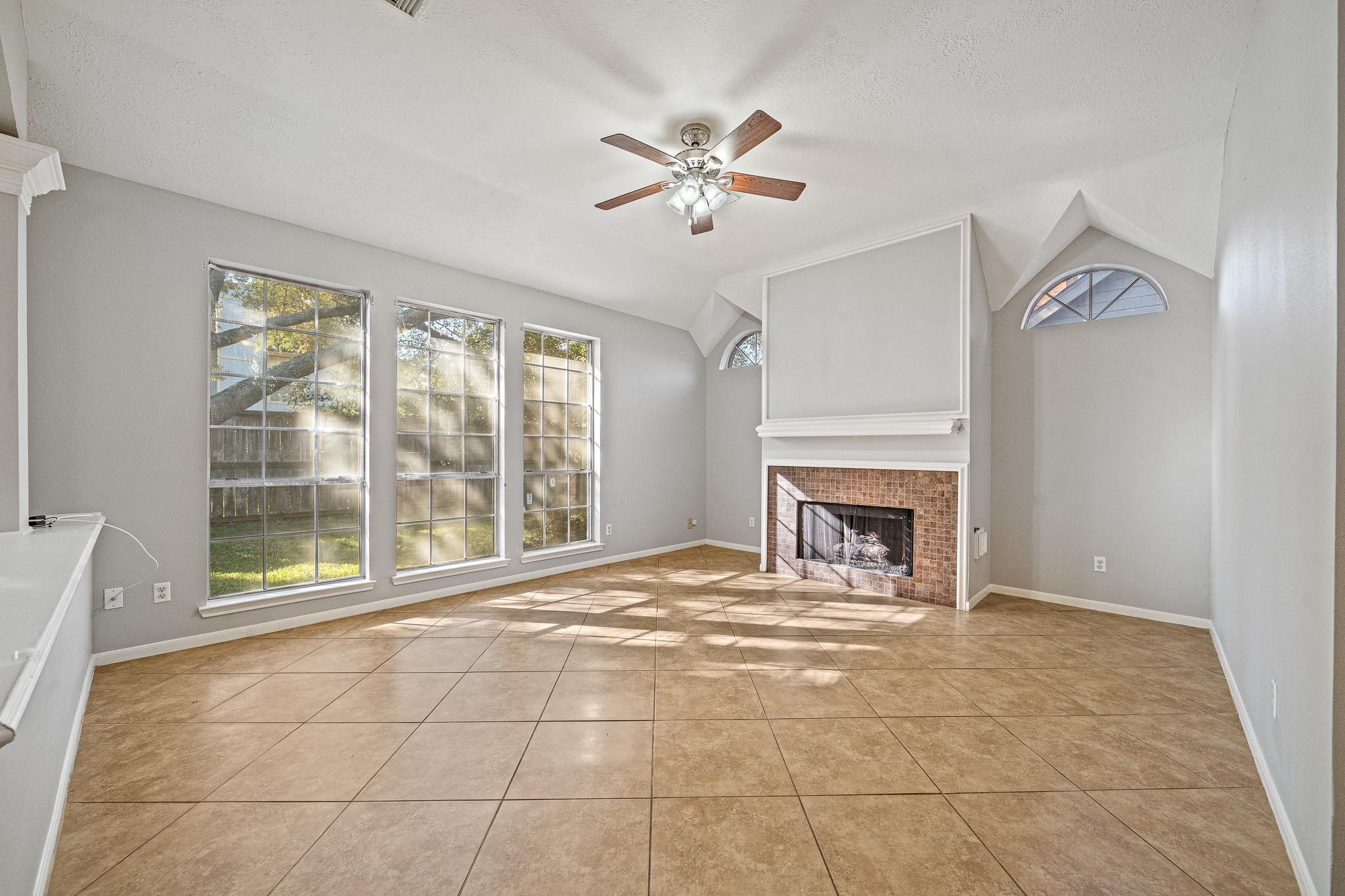 23223 Hazel Field Court Katy, TX 77494 - Photo 16 of 27 a view of an empty room with a fireplace and a window