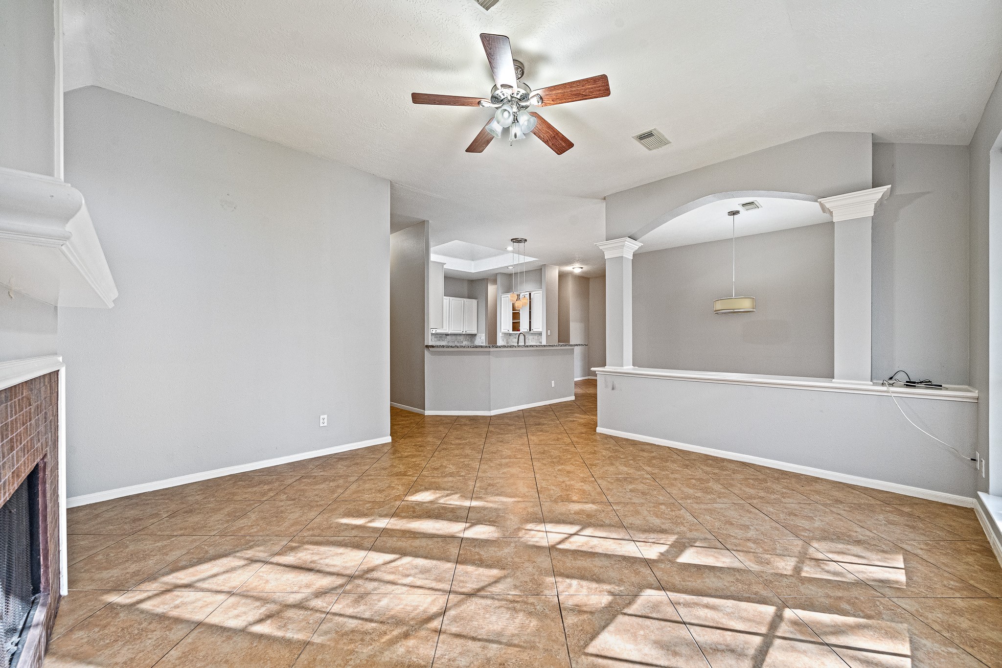 23223 Hazel Field Court Katy, TX 77494 - Photo 17 of 27 a view of a livingroom with a kitchen and a stove top oven