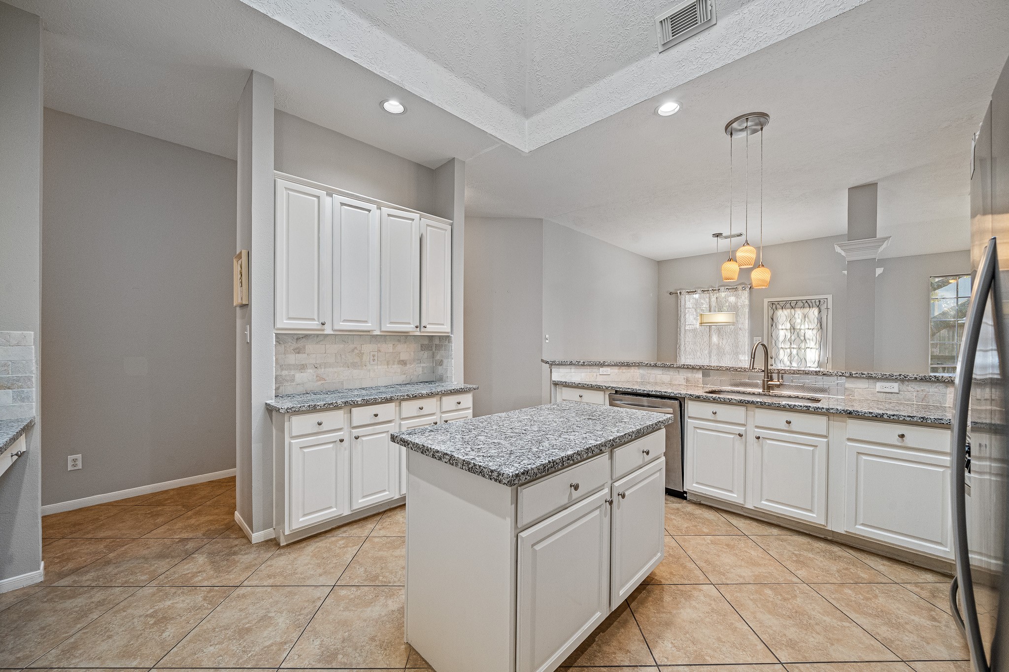 23223 Hazel Field Court Katy, TX 77494 - Photo 19 of 27 a kitchen with granite countertop white cabinets and white appliances