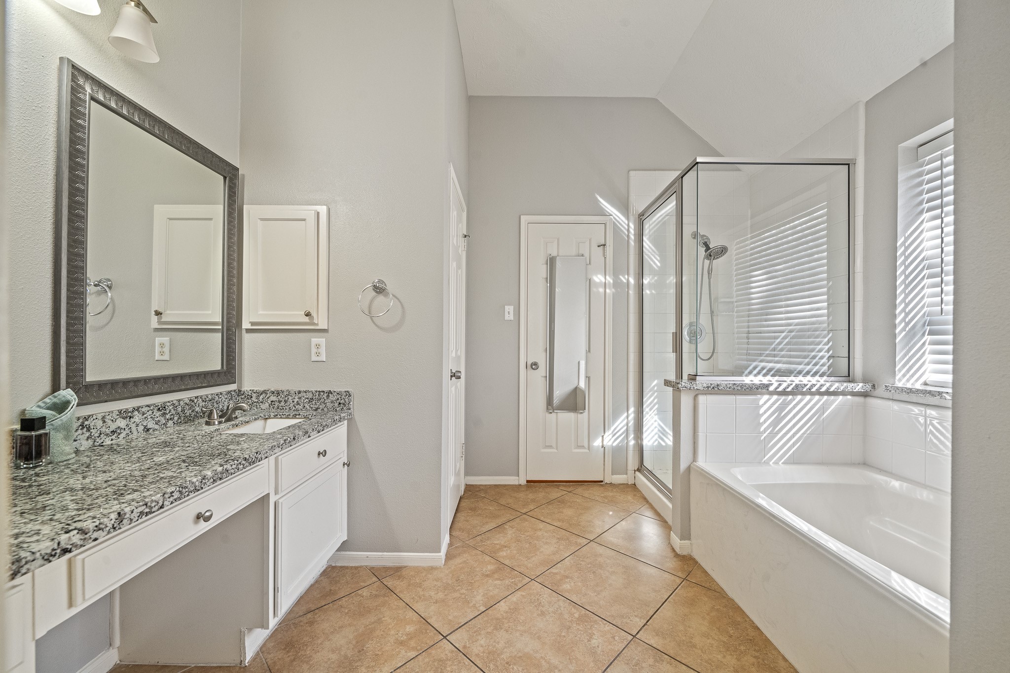 23223 Hazel Field Court Katy, TX 77494 - Photo 22 of 27 a spacious bathroom with a granite countertop tub sink and mirror