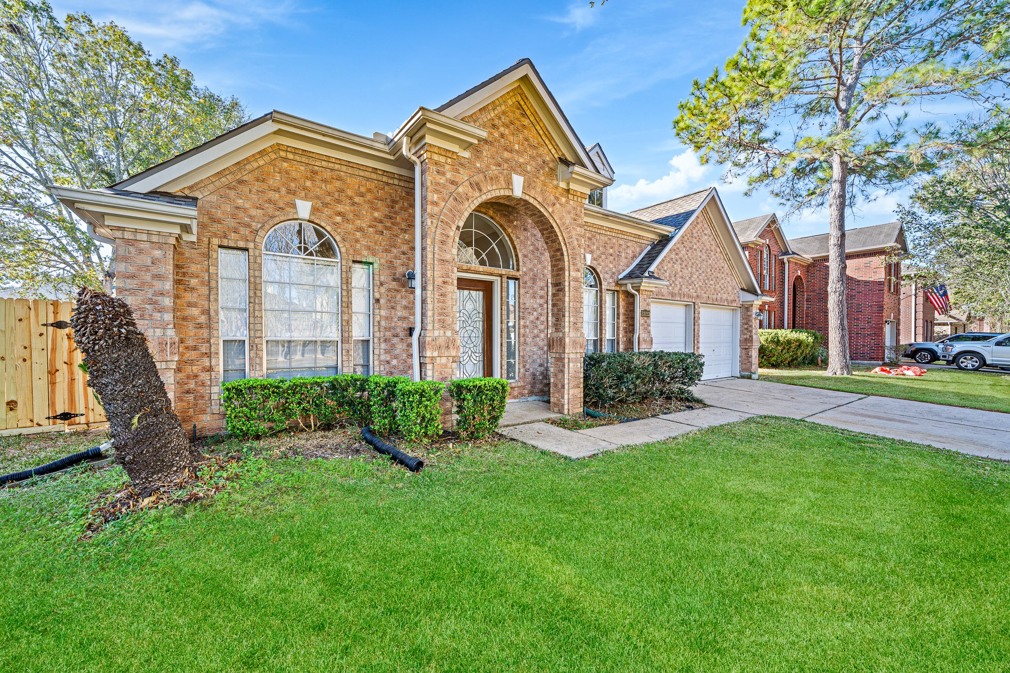23223 Hazel Field Court Katy, TX 77494 - Photo 3 of 27 a front view of a house with a garden and plants