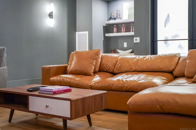 a living room with furniture and painting on the wall