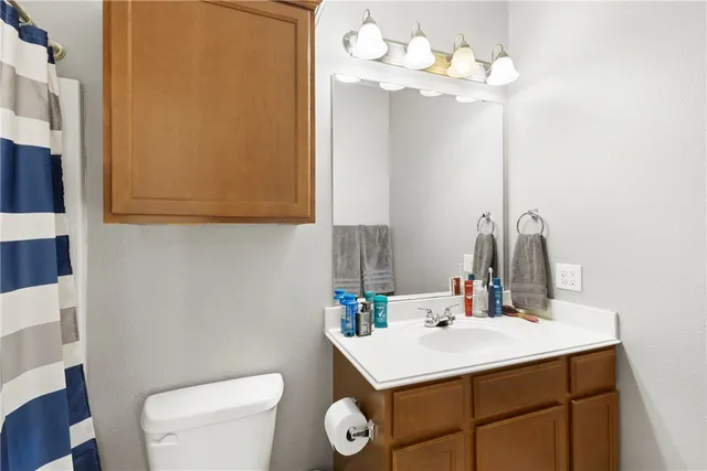 a bathroom with a sink vanity and a mirror