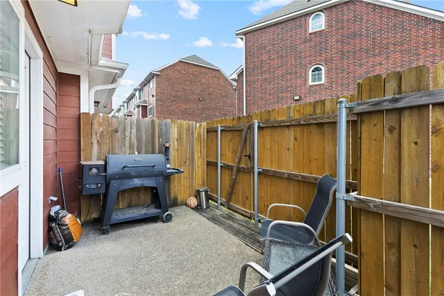 a view of roof deck with table and chairs