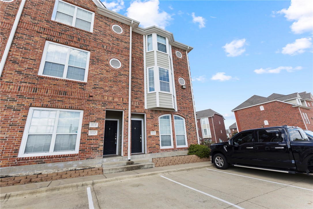 1198 Jones-Butler Road, Unit 3114 College Station, TX 77840 - Photo 5 of 13 a car parked in front of a brick house