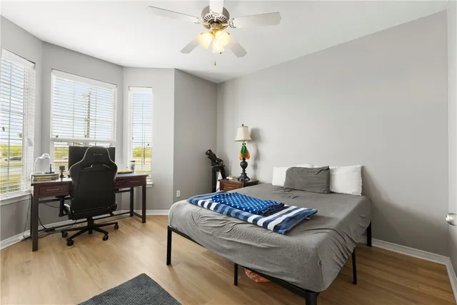 a bedroom with a bed and a desk