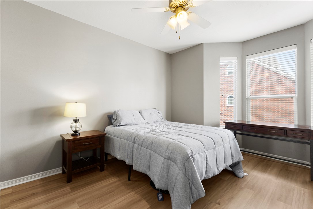 1198 Jones-Butler Road, Unit 3114 College Station, TX 77840 - Photo 8 of 13 a bedroom with a bed and a chandelier