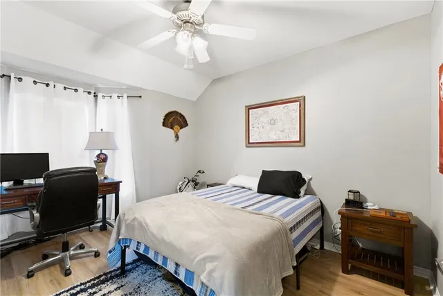 a bedroom with a bed and a desk