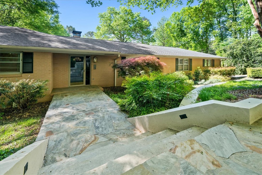 This charming home offers a brick exterior with inviting landscaping, promising comfortable living.