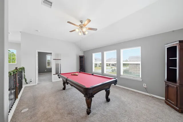 a spacious bedroom with a bed and a window