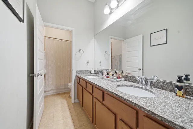 a bathroom with a tub shower and sink