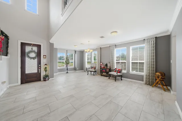 a view of a livingroom with furniture and a large window
