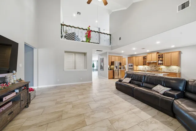 a kitchen with stainless steel appliances granite countertop a granite counter tops and a view of living room