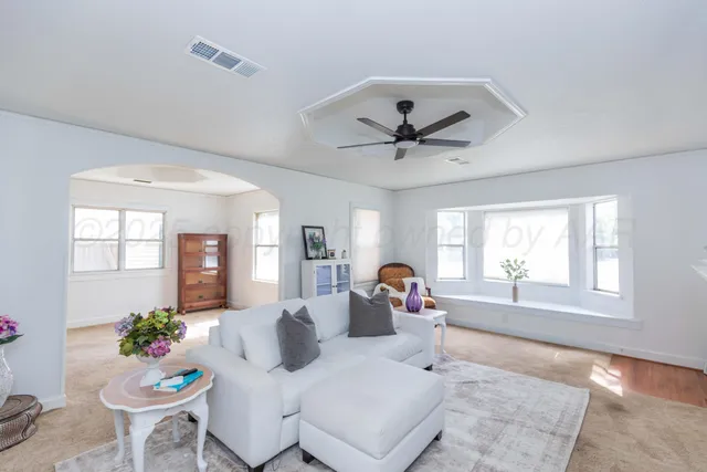 a living room with furniture and a large window