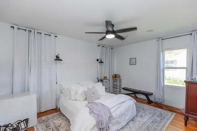 a bedroom with a bed furniture and a window