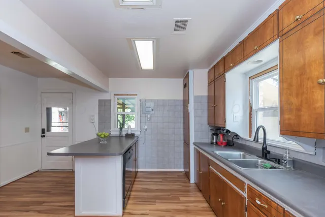 a kitchen with granite countertop a sink and a window