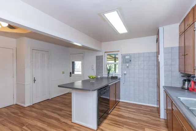a kitchen with sink and refrigerator