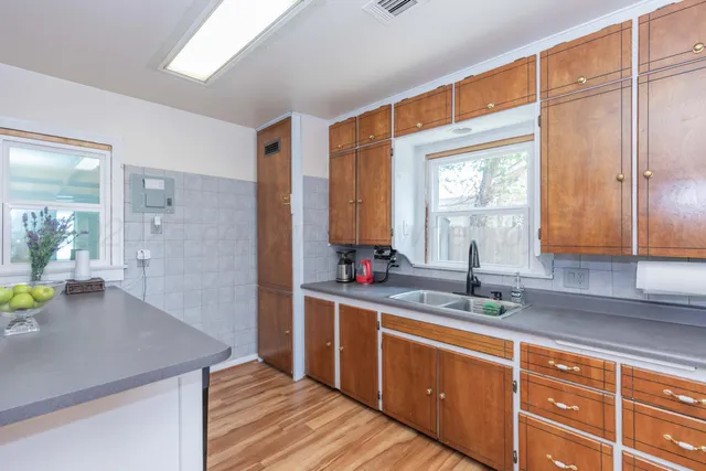 a kitchen with stainless steel appliances granite countertop a sink stove and cabinets