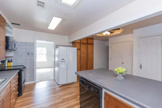 a kitchen with stainless steel appliances a refrigerator and a stove