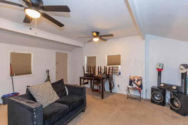 a living room with furniture and a chair