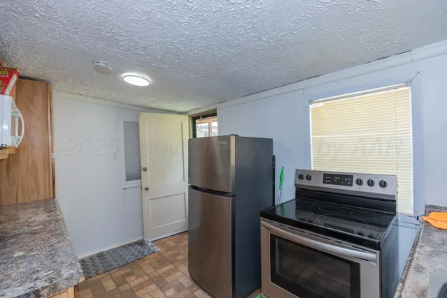 a kitchen with a refrigerator stove and microwave