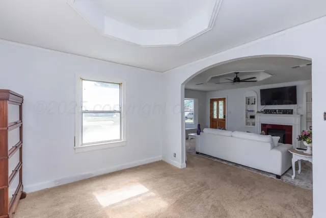 a living room with furniture and a fireplace