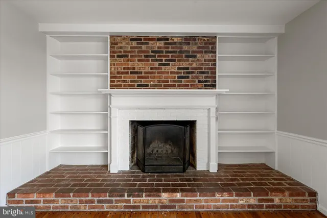 a living room with a fireplace and a fireplace