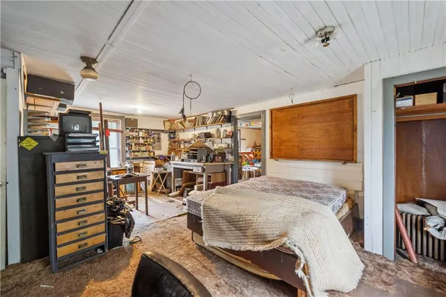 a bedroom with furniture a flat screen tv and a table