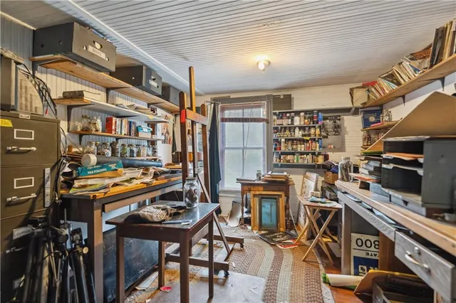 a bed sitting in a bedroom next to a window