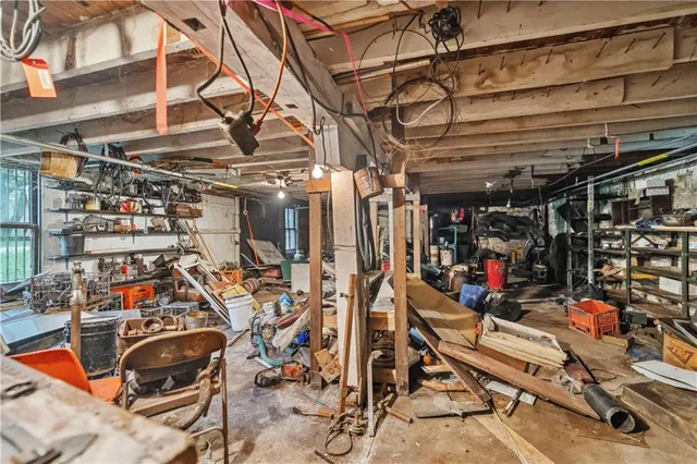 a view of a house with a lush green forest